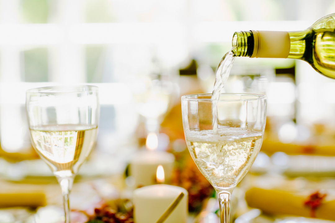White wine being poured in glasses